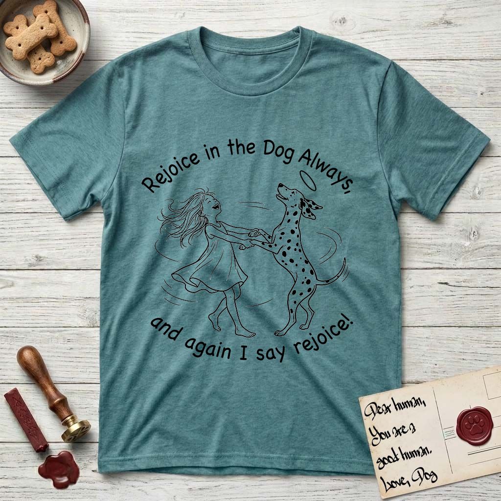 Rejoice in the Dog Dalmatian T-Shirt flat lay in Heather Galapagos Blue, featuring a sparse pen-and-ink illustration of a girl and her Dalmatian spinning together, both heads thrown back in joy.