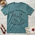 Rejoice in the Dog Dalmatian T-Shirt flat lay in Heather Galapagos Blue, featuring a sparse pen-and-ink illustration of a girl and her Dalmatian spinning together, both heads thrown back in joy.