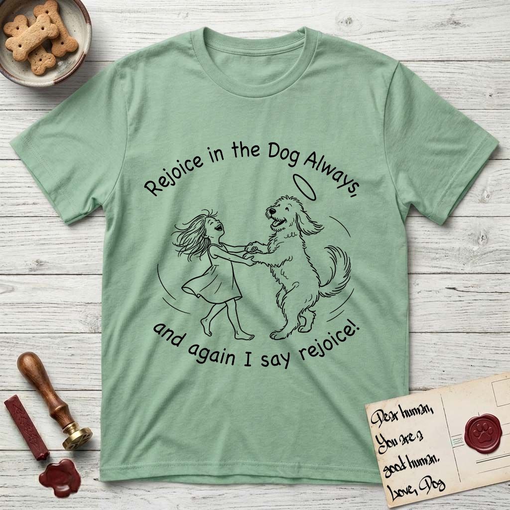 Rejoice in the Dog Goldendoodle T-Shirt flat lay in Mint Green, featuring a sparse pen-and-ink illustration of a girl and her Goldendoodle dancing together, fur flying, both heads thrown back.