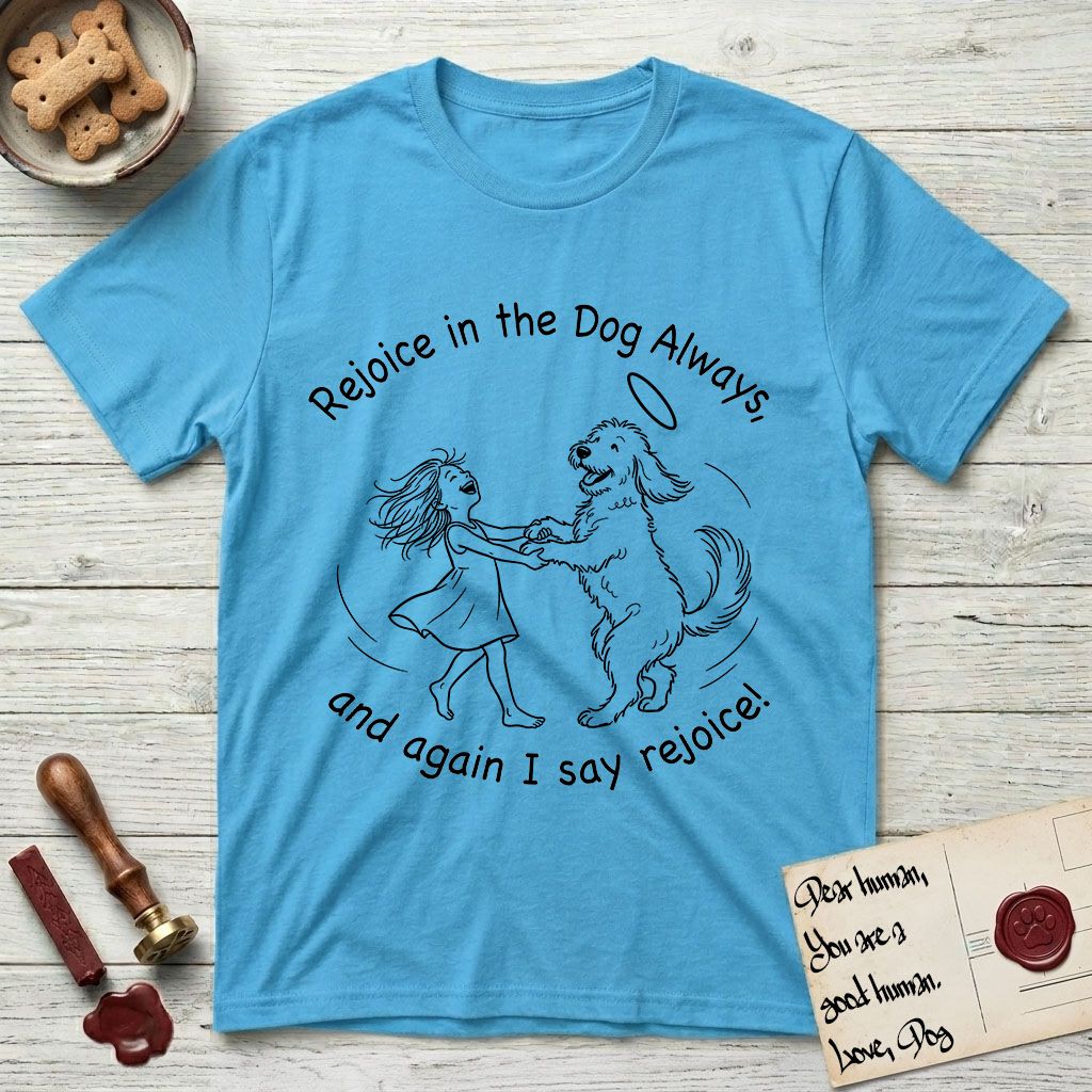 Rejoice in the Dog Goldendoodle T-Shirt flat lay in Sky, featuring a sparse pen-and-ink illustration of a girl and her Goldendoodle dancing together, fur flying, both heads thrown back.