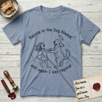 Rejoice in the Dog Goldendoodle T-Shirt flat lay in Stone Blue, featuring a sparse pen-and-ink illustration of a girl and her Goldendoodle dancing together, fur flying, both heads thrown back.
