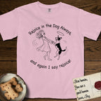 Rejoice in the Dog Lobo T-Shirt flat lay in Blossom, featuring a sparse pen-and-ink illustration of a girl and her haloed Dog Lobo spinning together, hands and paws clasped.