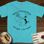 Rejoice in the Dog Lobo T-Shirt flat lay in Lagoon Blue, featuring a sparse pen-and-ink illustration of a girl and her haloed Dog Lobo spinning together, hands and paws clasped.