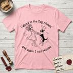 Rejoice in the Dog Lobo T-Shirt flat lay in Light Pink, featuring a sparse pen-and-ink illustration of a girl and her haloed Dog Lobo spinning together, hands and paws clasped.