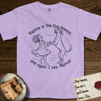 Rejoice in the Dog Rhodesian Ridgeback T-Shirt flat lay in Orchid, featuring a sparse pen-and-ink illustration of a girl and her Rhodesian Ridgeback spinning together, hands and paws clasped.