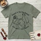 Rejoice in the Dog Rhodesian Ridgeback T-Shirt flat lay in Sage, featuring a sparse pen-and-ink illustration of a girl and her Rhodesian Ridgeback spinning together, hands and paws clasped.