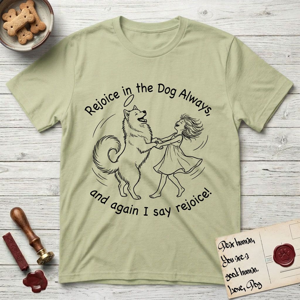 Rejoice in the Dog Samoyed T-Shirt flat lay in Pistachio, featuring a sparse pen-and-ink illustration of a girl and her smiling Samoyed spinning together, hands and paws clasped.