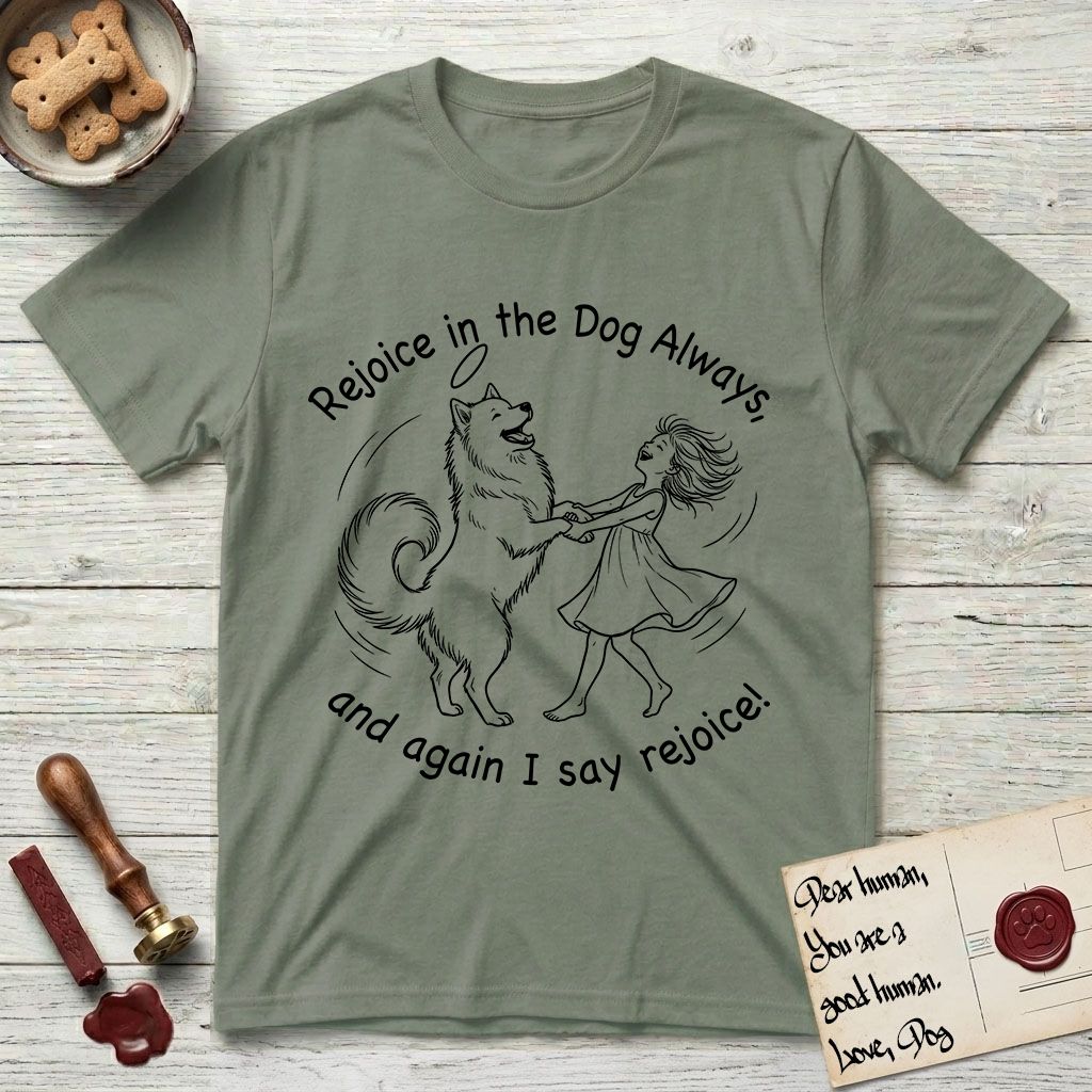 Rejoice in the Dog Samoyed T-Shirt flat lay in Sage, featuring a sparse pen-and-ink illustration of a girl and her smiling Samoyed spinning together, hands and paws clasped.