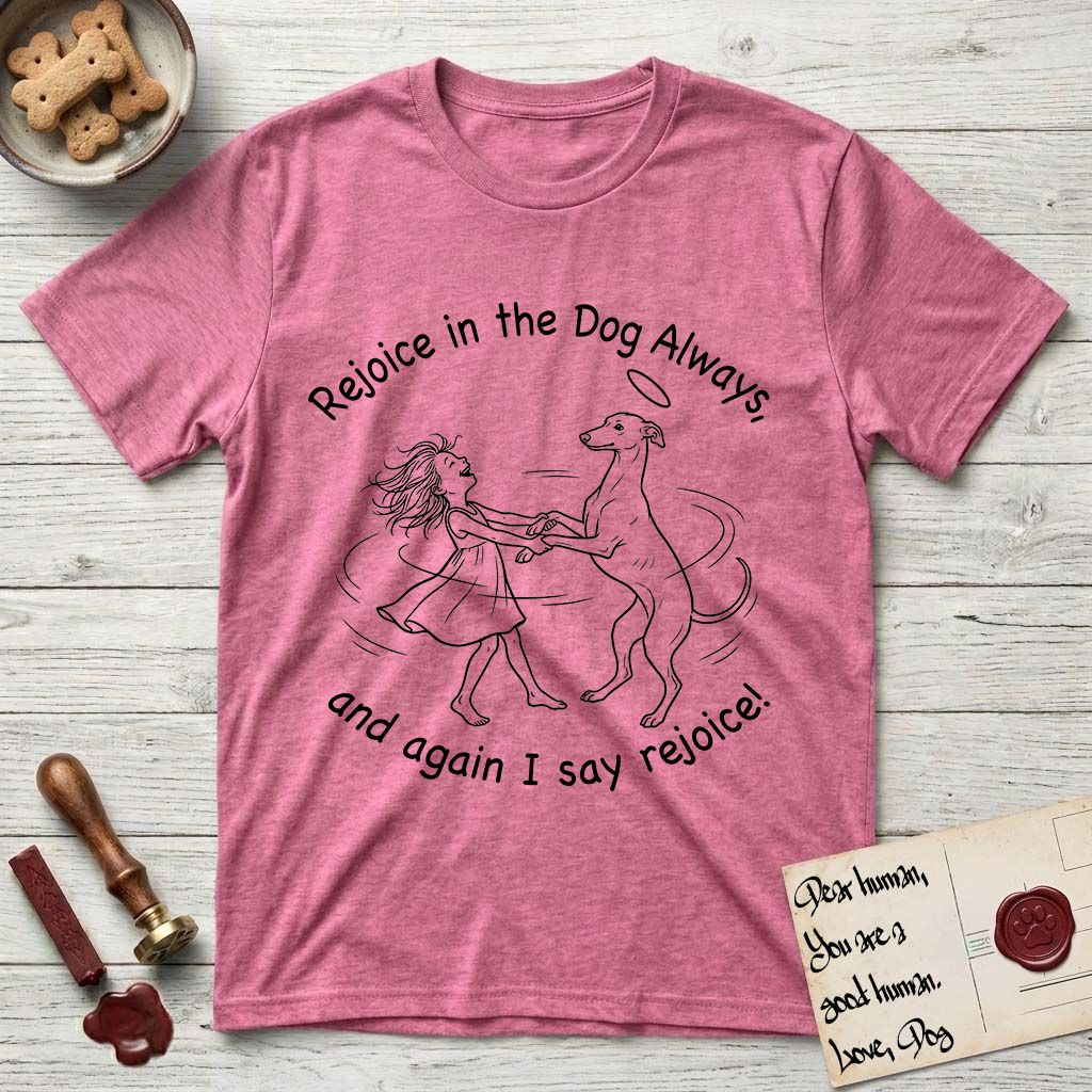 Rejoice in the Dog Whippet T-Shirt flat lay in Heather Heliconia, featuring a sparse pen-and-ink illustration of a girl and her Whippet dancing on his hind legs, both heads thrown back in joy.