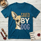 Saved by Dog Chihuahua T-Shirt flat lay in Antique Sapphire, featuring half a fawn Chihuahua's face in distressed vintage screen print, one huge upright ear and an enormous dark eye, cropped down the centerline beside bold stacked block lettering.