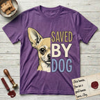 Saved by Dog Chihuahua T-Shirt flat lay in Heather Purple, featuring half a fawn Chihuahua's face in distressed vintage screen print, one huge upright ear and an enormous dark eye, cropped down the centerline beside bold stacked block lettering.