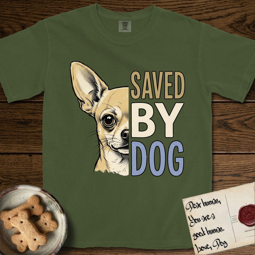 Saved by Dog Chihuahua T-Shirt flat lay in Hemp, featuring half a fawn Chihuahua's face in distressed vintage screen print, one huge upright ear and an enormous dark eye, cropped down the centerline beside bold stacked block lettering.