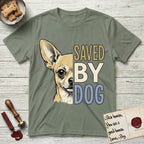 Saved by Dog Chihuahua T-Shirt flat lay in Sage, featuring half a fawn Chihuahua's face in distressed vintage screen print, one huge upright ear and an enormous dark eye, cropped down the centerline beside bold stacked block lettering.