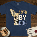 Saved by Dog Chihuahua T-Shirt flat lay in True Navy, featuring half a fawn Chihuahua's face in distressed vintage screen print, one huge upright ear and an enormous dark eye, cropped down the centerline beside bold stacked block lettering.