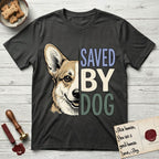 Saved by Dog Corgi T-Shirt flat lay in Charcoal, featuring half a tan-and-cream Corgi's face in distressed vintage screen print, one upright ear and a foxy grin, cropped down the centerline beside bold stacked block lettering.