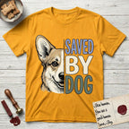 Saved by Dog Corgi T-Shirt flat lay in Gold, featuring half a tan-and-cream Corgi's face in distressed vintage screen print, one upright ear and a foxy grin, cropped down the centerline beside bold stacked block lettering.