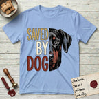 Saved by Dog Doberman T-Shirt flat lay in Light Blue, featuring half a black-and-rust Doberman's face in distressed vintage screen print, natural uncropped ears and a steady eye, cropped down the centerline beside bold stacked block lettering.