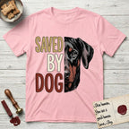Saved by Dog Doberman T-Shirt flat lay in Light Pink, featuring half a black-and-rust Doberman's face in distressed vintage screen print, natural uncropped ears and a steady eye, cropped down the centerline beside bold stacked block lettering.