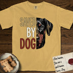 Saved by Dog Doberman T-Shirt flat lay in Mustard, featuring half a black-and-rust Doberman's face in distressed vintage screen print, natural uncropped ears and a steady eye, cropped down the centerline beside bold stacked block lettering.