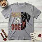 Saved by Dog Doberman T-Shirt flat lay in Sport Grey, featuring half a black-and-rust Doberman's face in distressed vintage screen print, natural uncropped ears and a steady eye, cropped down the centerline beside bold stacked block lettering.