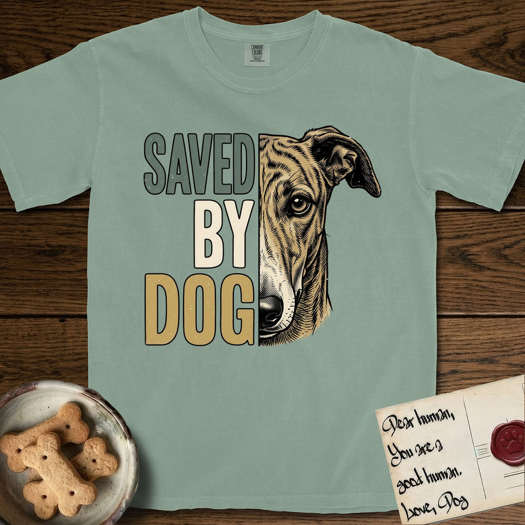 Saved by Dog Galgo T-Shirt flat lay in Bay, featuring half a brindle Galgo's face in distressed vintage screen print, a folded rose ear and a gentle eye, cropped down the centerline beside bold stacked block lettering.