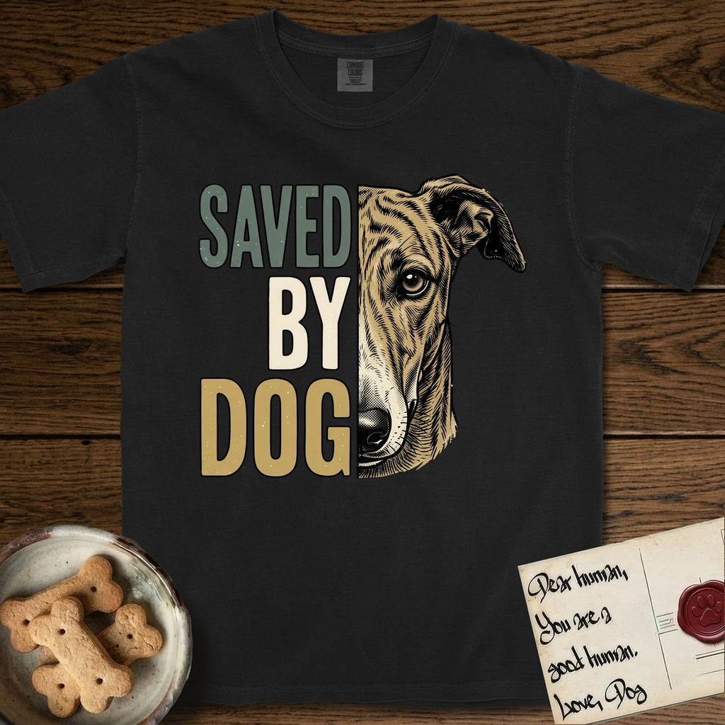 Saved by Dog Galgo T-Shirt flat lay in Black, featuring half a brindle Galgo's face in distressed vintage screen print, a folded rose ear and a gentle eye, cropped down the centerline beside bold stacked block lettering.