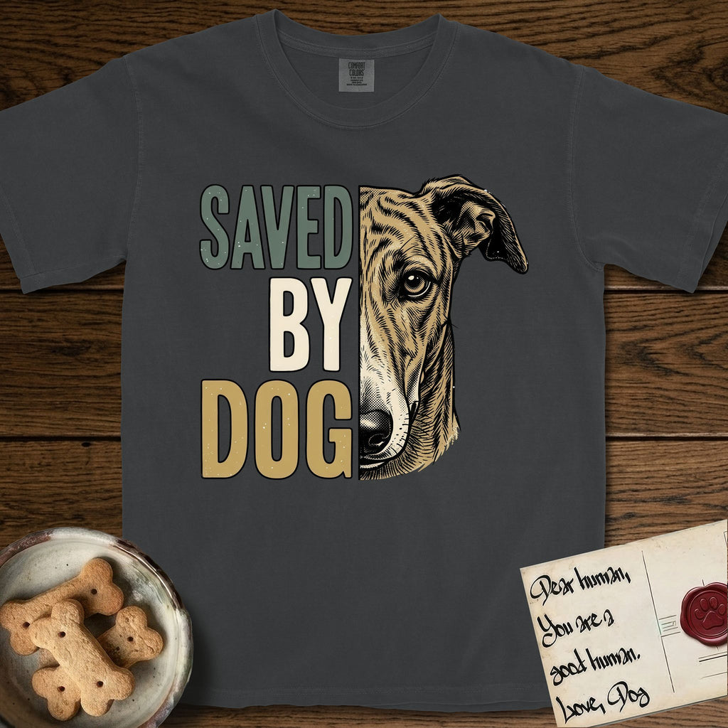 Saved by Dog Galgo T-Shirt flat lay in Graphite, featuring half a brindle Galgo's face in distressed vintage screen print, a folded rose ear and a gentle eye, cropped down the centerline beside bold stacked block lettering.