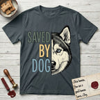 Saved by Dog Husky T-Shirt flat lay in Dark Heather Grey, featuring half a black-and-white Husky's face in distressed vintage screen print, one pale ice-blue eye, cropped down the centerline beside bold stacked block lettering.