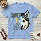 Saved by Dog Husky T-Shirt flat lay in Light Blue, featuring half a black-and-white Husky's face in distressed vintage screen print, one pale ice-blue eye, cropped down the centerline beside bold stacked block lettering.