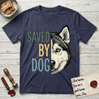 Saved by Dog Husky T-Shirt flat lay in Navy, featuring half a black-and-white Husky's face in distressed vintage screen print, one pale ice-blue eye, cropped down the centerline beside bold stacked block lettering.