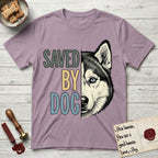 Saved by Dog Husky T-Shirt flat lay in Paragon, featuring half a black-and-white Husky's face in distressed vintage screen print, one pale ice-blue eye, cropped down the centerline beside bold stacked block lettering.