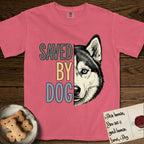 Saved by Dog Husky T-Shirt flat lay in Watermelon, featuring half a black-and-white Husky's face in distressed vintage screen print, one pale ice-blue eye, cropped down the centerline beside bold stacked block lettering.