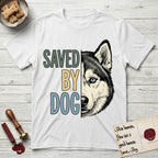 Saved by Dog Husky T-Shirt flat lay in White, featuring half a black-and-white Husky's face in distressed vintage screen print, one pale ice-blue eye, cropped down the centerline beside bold stacked block lettering.