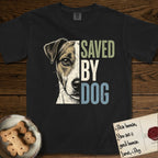 Saved by Dog Jack Russell T-Shirt flat lay in Black, featuring half a tan-and-white Jack Russell's face in distressed vintage screen print, a folded ear with a dark patch and forward whiskers, cropped down the centerline beside bold stacked block lettering.