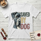 Saved by Dog Pitbull T-Shirt flat lay in White, featuring half a blue-grey Pitbull's face in distressed vintage screen print, one warm amber eye, cropped down the centerline beside bold stacked block lettering.