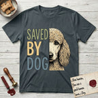 Saved by Dog Poodle T-Shirt flat lay in Dark Heather Grey, featuring half an apricot Poodle's face in distressed vintage screen print, soft natural curls and a knowing eye, cropped down the centerline beside bold stacked block lettering.