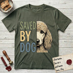Saved by Dog Poodle T-Shirt flat lay in Heather Military Green, featuring half an apricot Poodle's face in distressed vintage screen print, soft natural curls and a knowing eye, cropped down the centerline beside bold stacked block lettering.