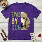 Saved by Dog Poodle T-Shirt flat lay in Purple, featuring half an apricot Poodle's face in distressed vintage screen print, soft natural curls and a knowing eye, cropped down the centerline beside bold stacked block lettering.