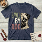 Saved by Dog Pug T-Shirt flat lay in Heather Navy, featuring half a fawn Pug's face in distressed vintage screen print, a dark mask and one large round eye, cropped down the centerline beside bold stacked block lettering.