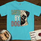 Saved by Dog Pug T-Shirt flat lay in Lagoon Blue, featuring half a fawn Pug's face in distressed vintage screen print, a dark mask and one large round eye, cropped down the centerline beside bold stacked block lettering.