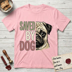 Saved by Dog Pug T-Shirt flat lay in Light Pink, featuring half a fawn Pug's face in distressed vintage screen print, a dark mask and one large round eye, cropped down the centerline beside bold stacked block lettering.