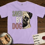 Saved by Dog Pug T-Shirt flat lay in Orchid, featuring half a fawn Pug's face in distressed vintage screen print, a dark mask and one large round eye, cropped down the centerline beside bold stacked block lettering.