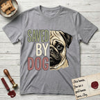 Saved by Dog Pug T-Shirt flat lay in Sport Grey, featuring half a fawn Pug's face in distressed vintage screen print, a dark mask and one large round eye, cropped down the centerline beside bold stacked block lettering.