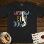 Saved by Dog Whippet T-Shirt flat lay in Black, featuring half a blue-grey Whippet's face in distressed vintage screen print, a folded rose ear and a large liquid eye, cropped down the centerline beside bold stacked block lettering.