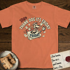 Thank Dog It's Friday T-Shirt flat lay in Melon, featuring a retro 1930s cartoon of a Dog bursting through a Friday calendar page, surrounded by musical notes, stars, and a clock, with retro display lettering reading TDIF.