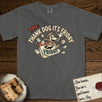 Thank Dog It's Friday T-Shirt flat lay in Pepper, featuring a retro 1930s cartoon of a Dog bursting through a Friday calendar page, surrounded by musical notes, stars, and a clock, with retro display lettering reading TDIF.