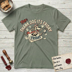Thank Dog It's Friday T-Shirt flat lay in Sage, featuring a retro 1930s cartoon of a Dog bursting through a Friday calendar page, surrounded by musical notes, stars, and a clock, with retro display lettering reading TDIF.