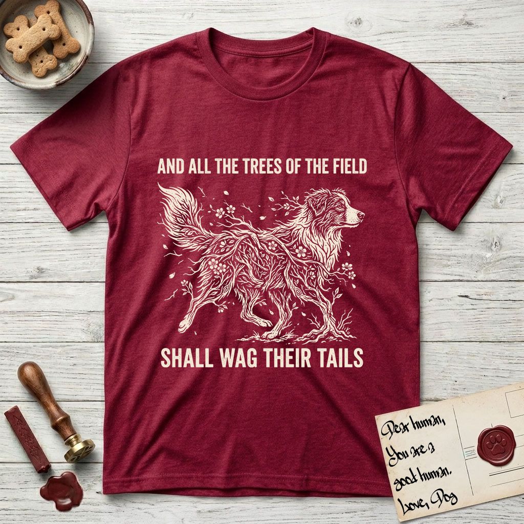 Trees of the Field Australian Shepherd T-Shirt flat lay in Antique Cherry Red, featuring a vintage woodcut illustration of an Australian Shepherd formed of flowering cherry branches, mid-stride, with the words And All the Trees of the Field Shall Wag Their Tails.