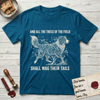 Trees of the Field Australian Shepherd T-Shirt flat lay in Antique Sapphire, featuring a vintage woodcut illustration of an Australian Shepherd formed of flowering cherry branches, mid-stride, with the words And All the Trees of the Field Shall Wag Their Tails.