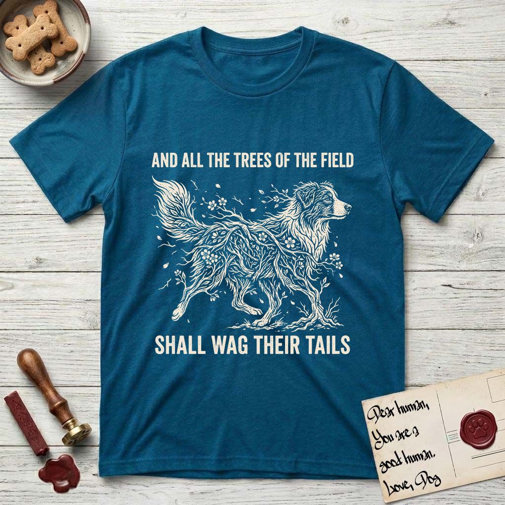 Trees of the Field Australian Shepherd T-Shirt flat lay in Antique Sapphire, featuring a vintage woodcut illustration of an Australian Shepherd formed of flowering cherry branches, mid-stride, with the words And All the Trees of the Field Shall Wag Their Tails.